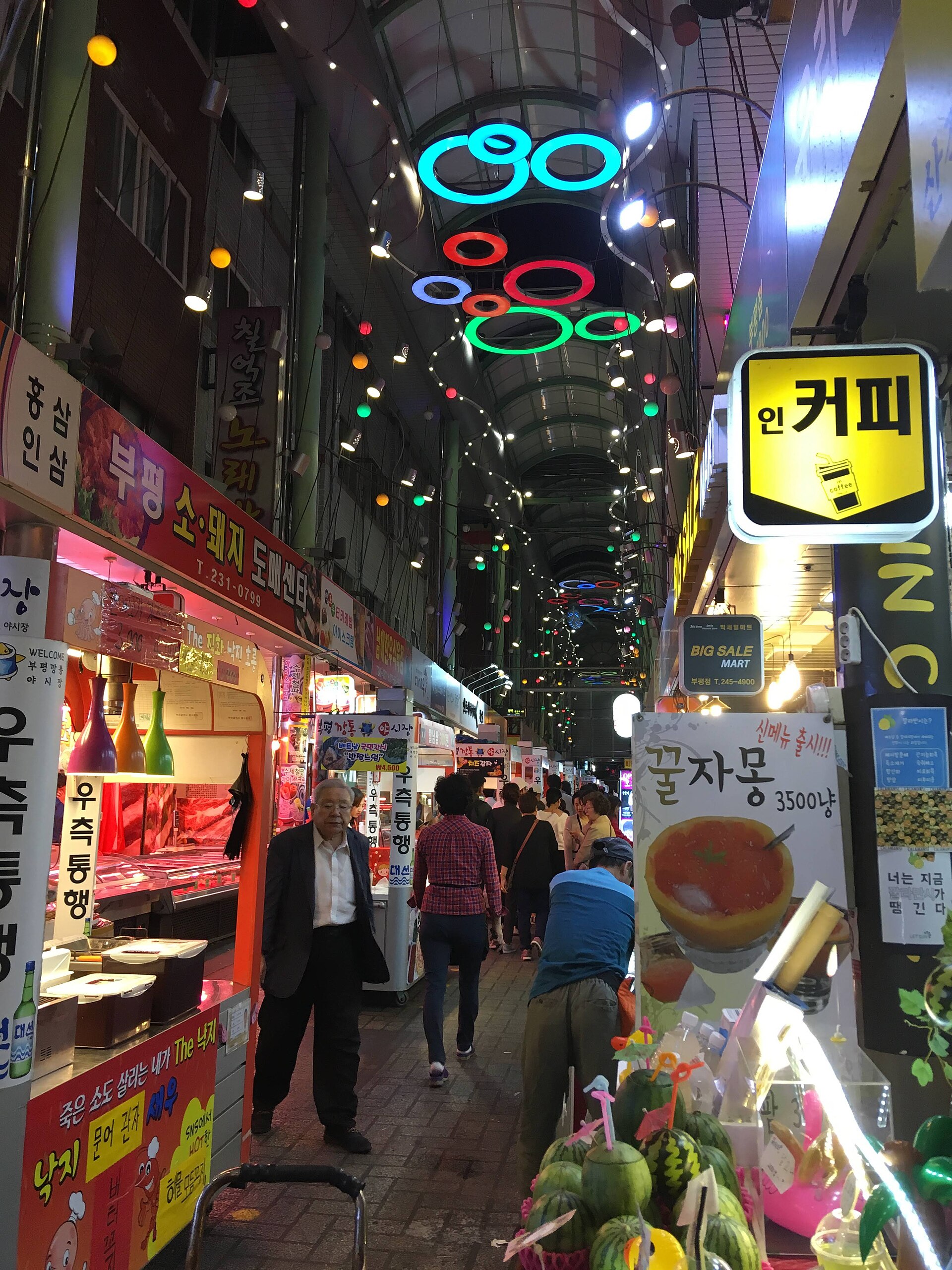 Neon-lit night market alley at Bupyeong Kkangtong