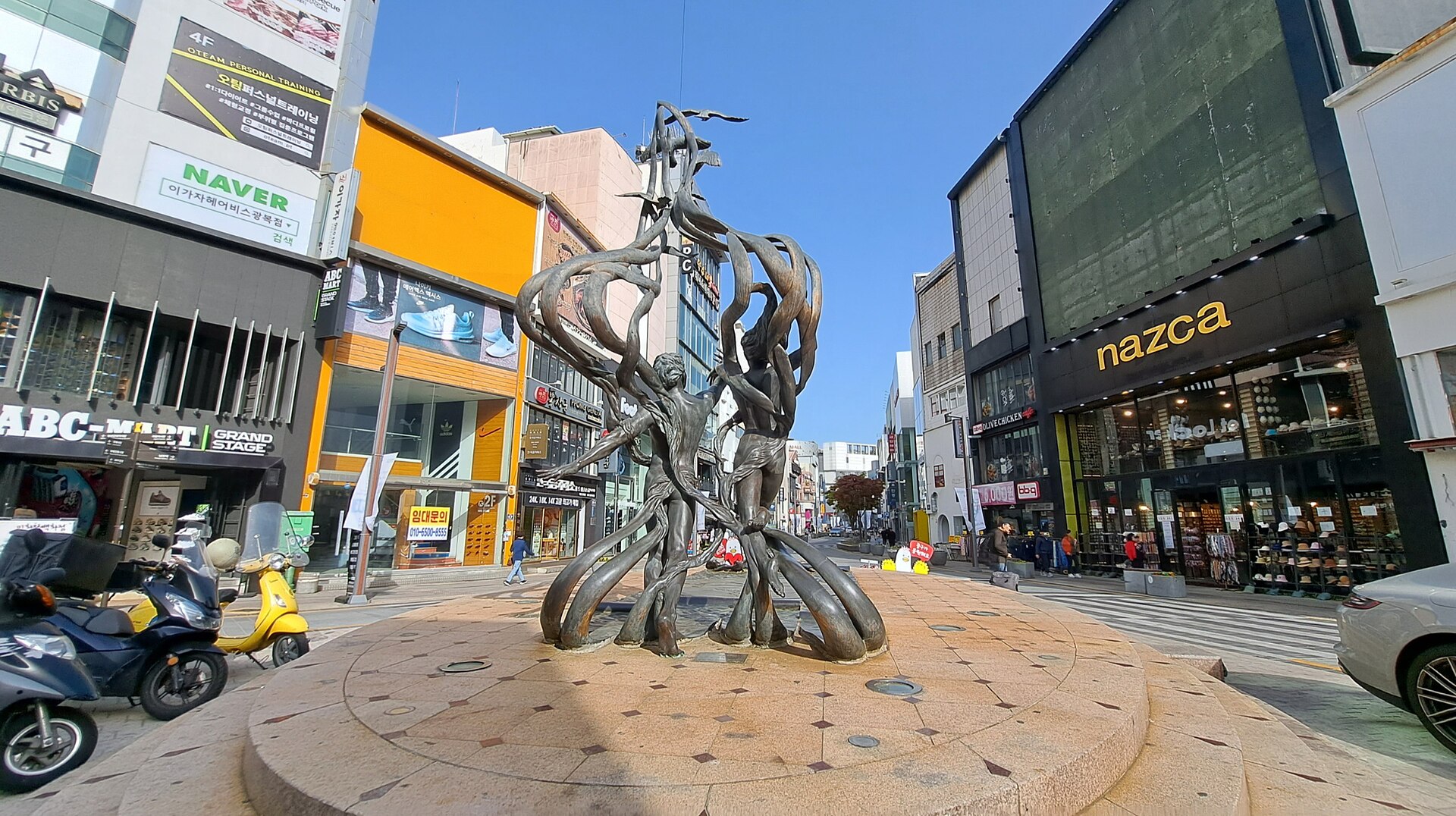 Shops and a public sculpture in the shopping streets near Gukje Market, Busan