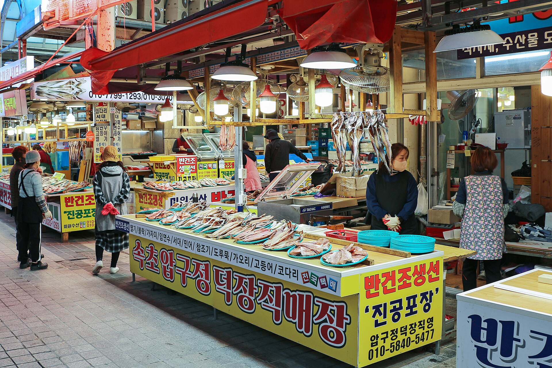 Dried fish stall with yellow Korean signage in Sokcho